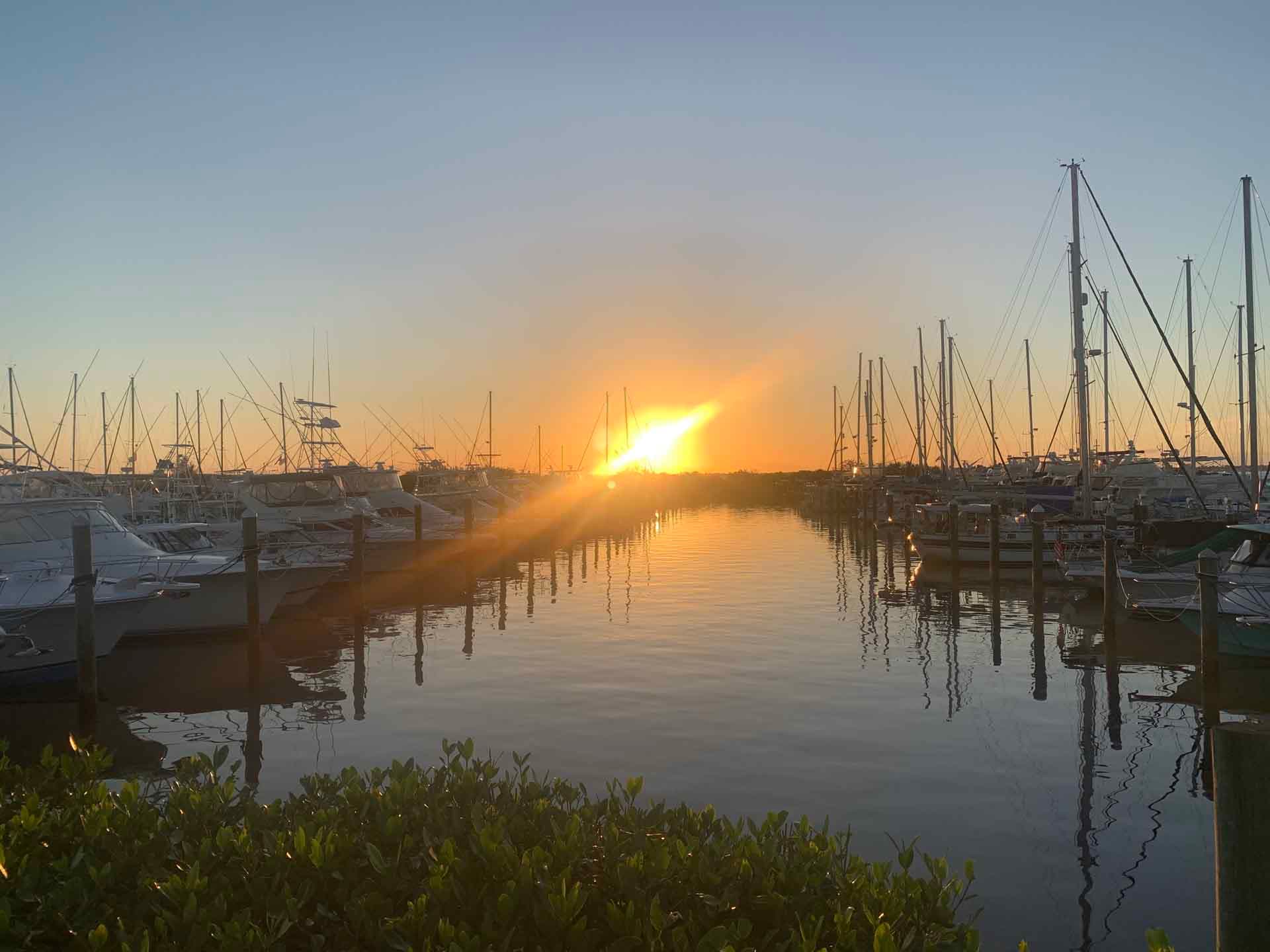 Sunset over the water at Loveridge Yachts' marina